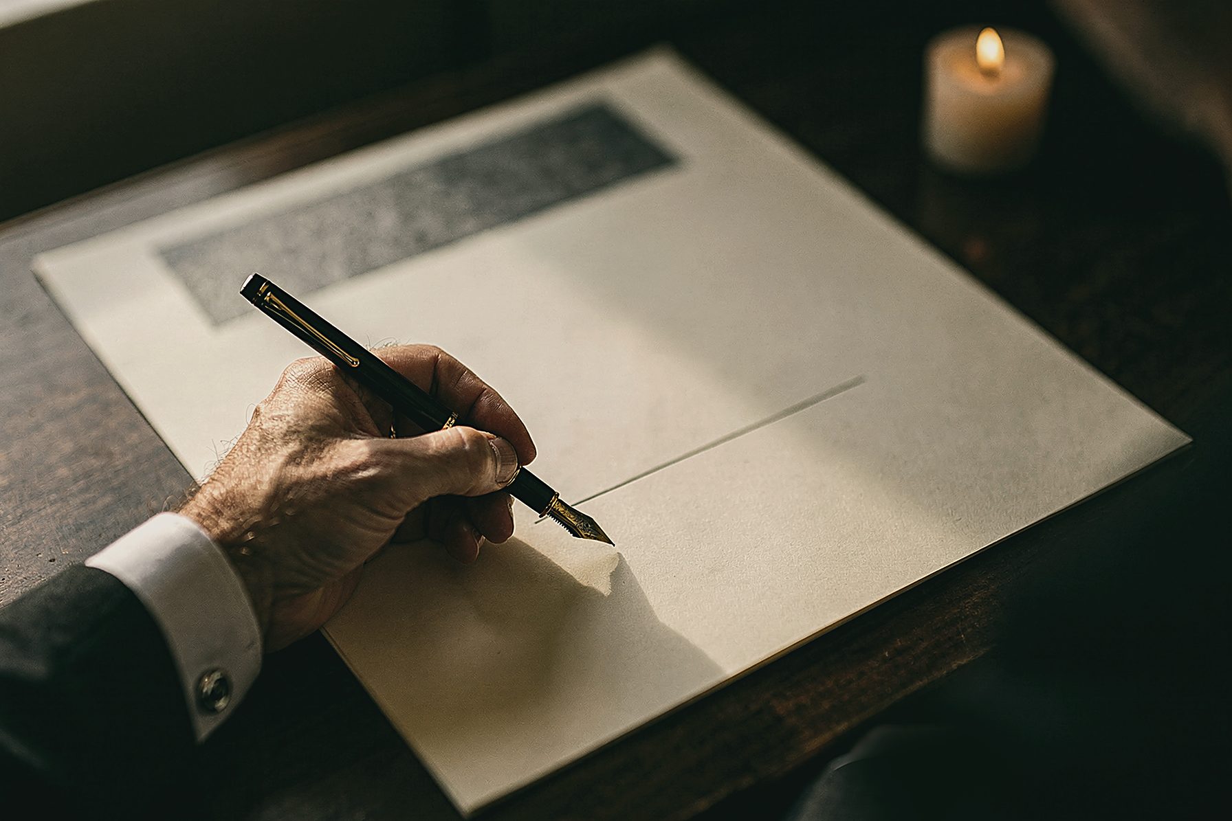 A fountain pen held over a blank sheet. PLACEHOLDER house still.